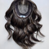 Volumateur capillaire ondulé pour alopécie androgénétique, manque de densité ou cheveux fins. Volumateur en cheveux naturels brésiliens châtain foncés illuminé de légères mèches blondes.